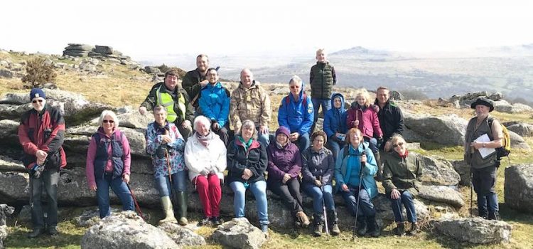 Group of walkers sat on Dartmoor tor